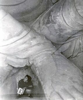 Under pressure, hiding between feet of a huge Buddha.(1959)